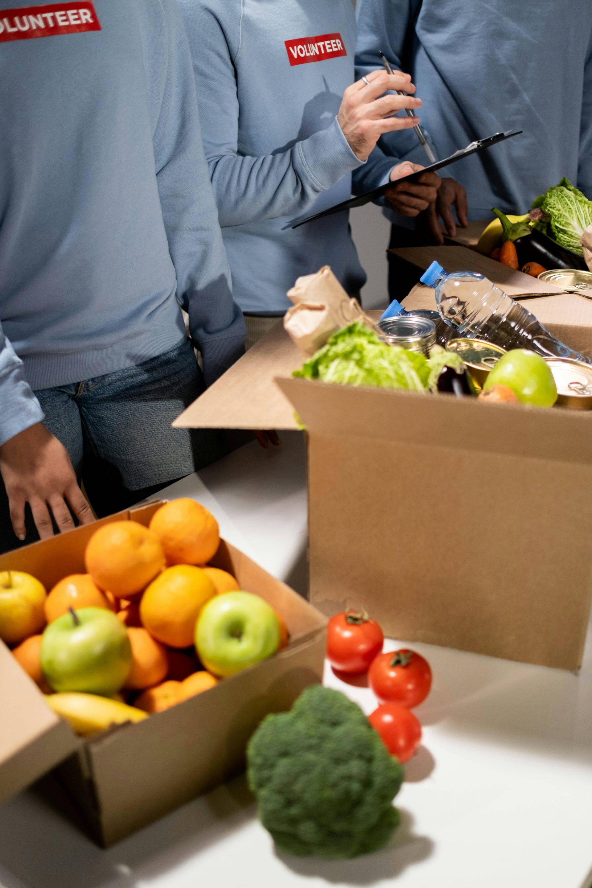 Energetic volunteers organize fresh fruits and vegetables for a community relief effort.